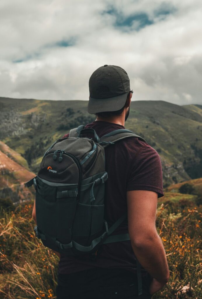 unsplash.com a man with a backpack standing on a hill krisztian toth l4rjwkx3syy